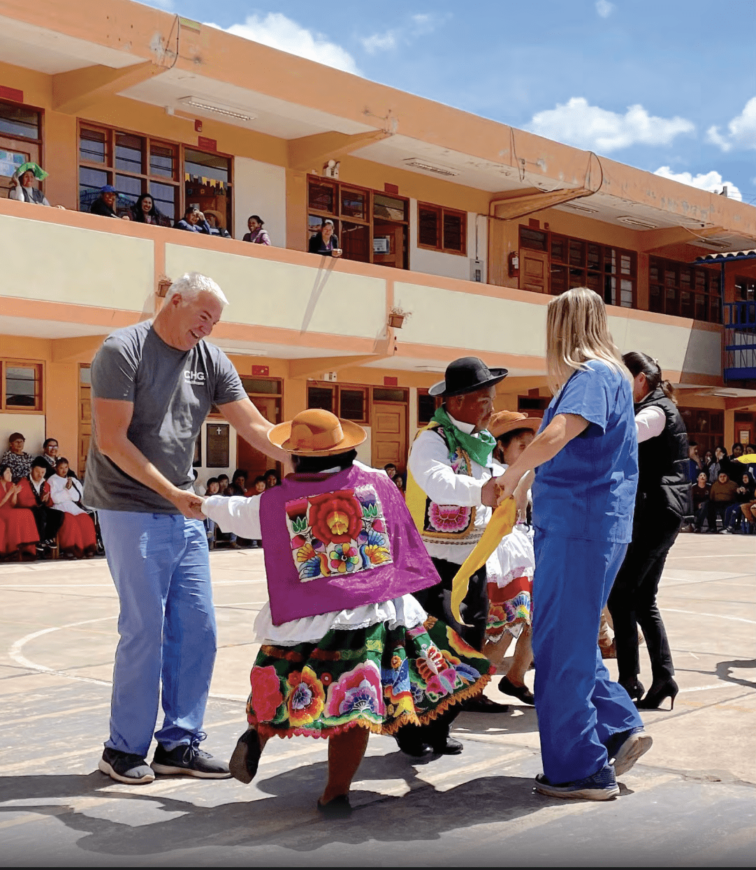 Providers and other people dancing in an open area