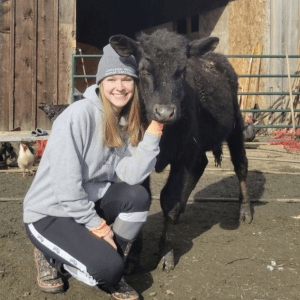 Girl wearing a hat with a black cow