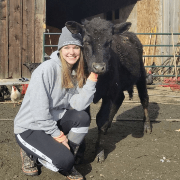 Girl wearing a hat with a black cow