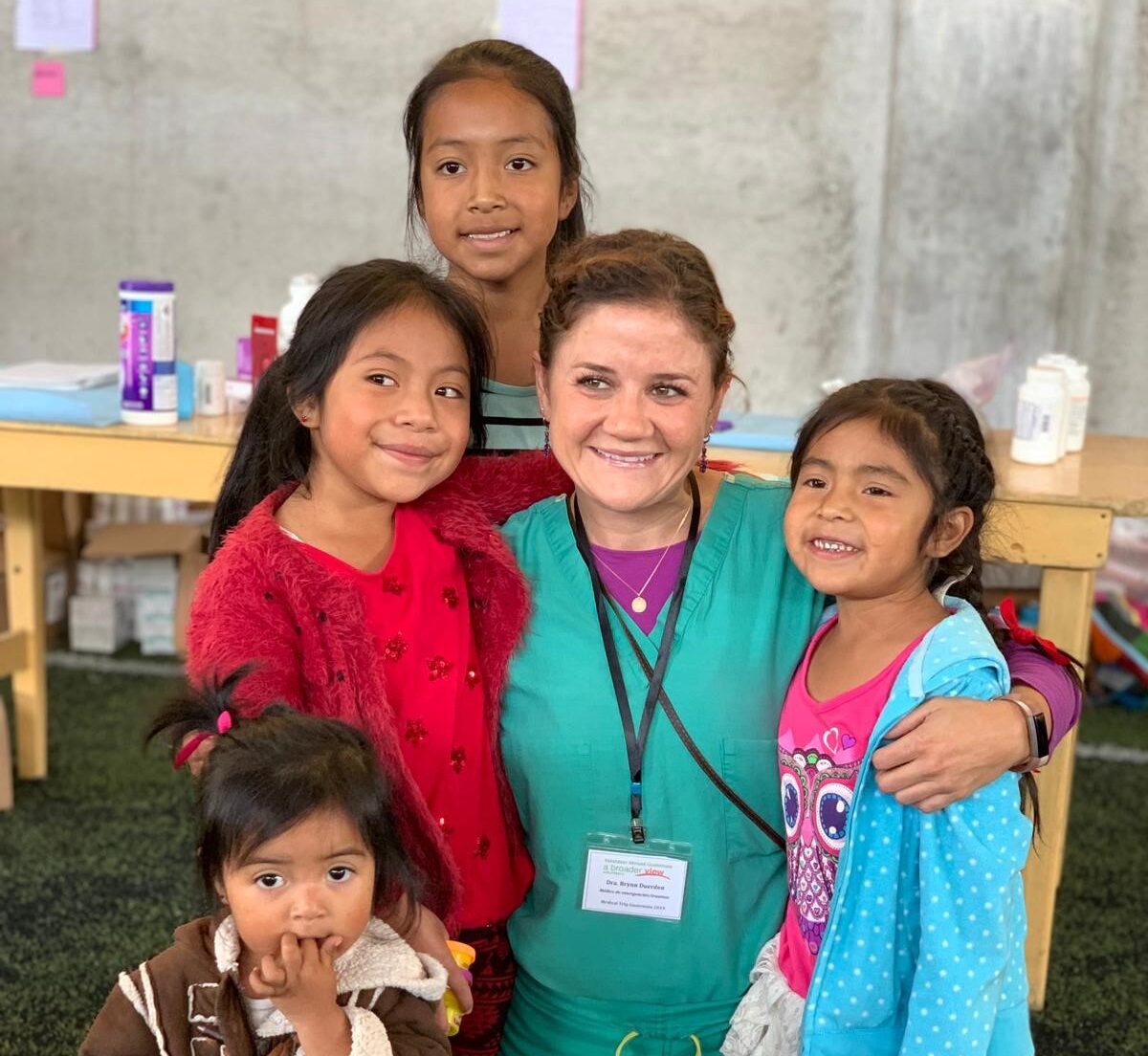 Female nurse surrounded by children